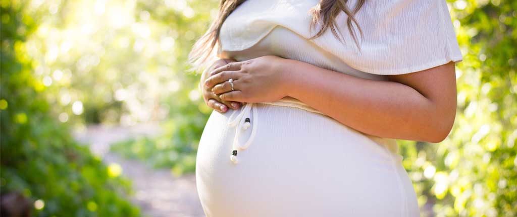 Pregnant women with hands on belly